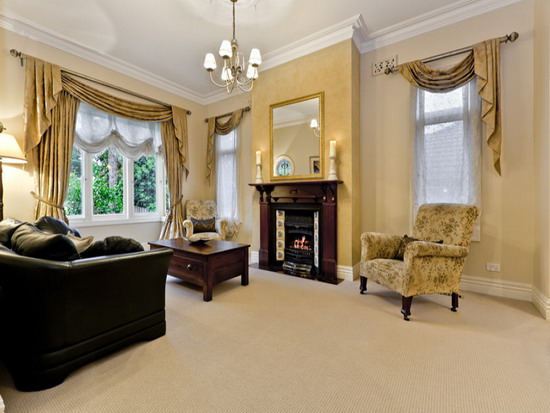 Black-Leather-Sofa-In-A-Traditional-Apartment-Living-Room-Design-With-Brown-Windows-Curtains-And-Fireplace - Copy