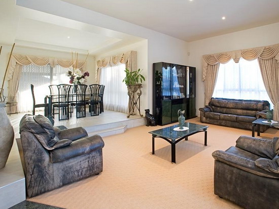 Grey-Comfortable-Sofa-In-A-Transitional-Apartment-Living-Room-Design-With-Windows-Curtains-And-Black-Display-Cabinets - Copy