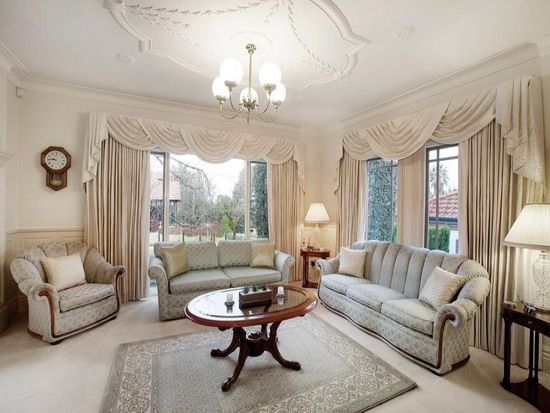 Round-Wooden-Coffee-Table-In-A-Traditional-Apartment-Living-Room-Design-With-Window-Curtains-And-Chandelier