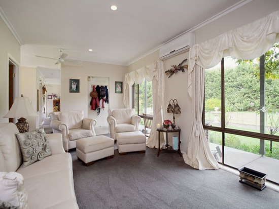 White-Window-Curtains-In-A-Transitional-Apartment-Living-Room-Design-With-Comfortable-White-Sofa-And-Grey-Area-Rug - Copy